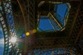 Bottom view of Eiffel Tower made in iron, with sunny blue sky in Paris. Royalty Free Stock Photo